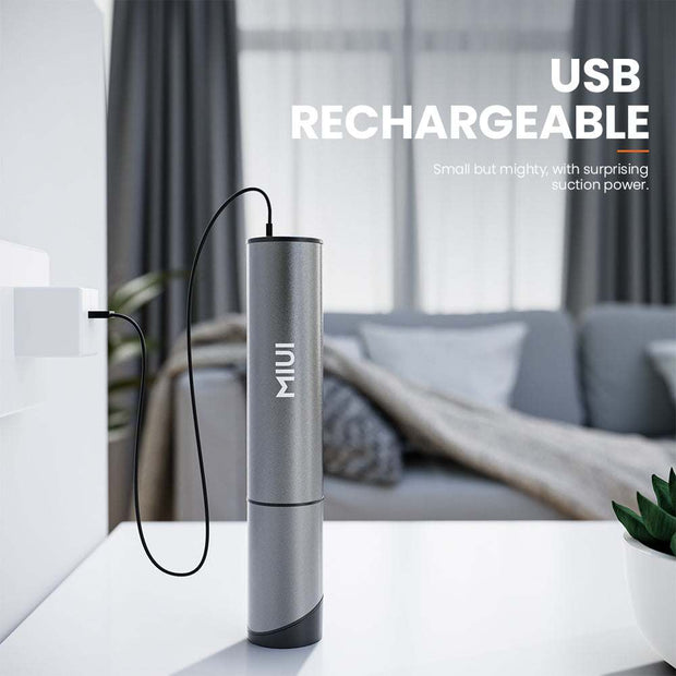 USB rechargeable MIUI Mini Vacuum Cleaner in sleek design on a modern table.